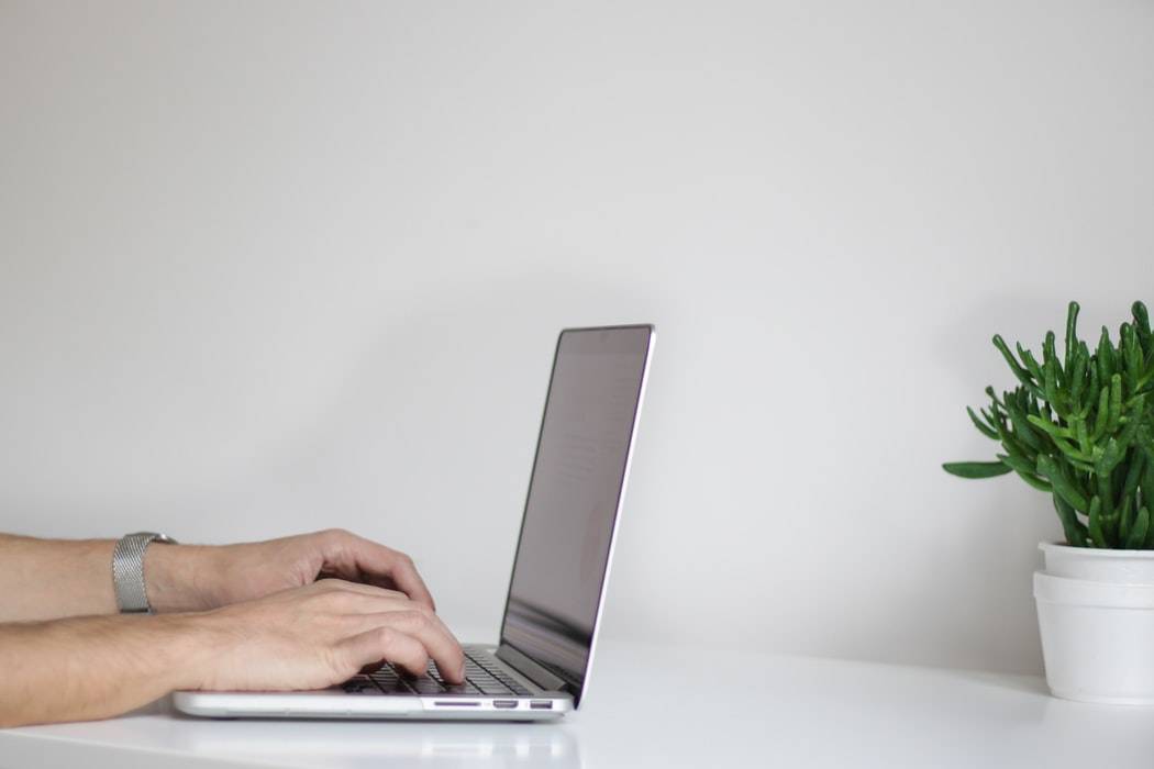 A student working on a laptop at a desk